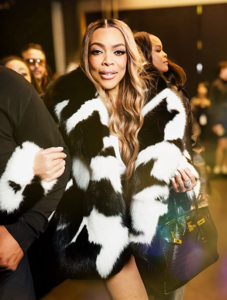 wendy williams spotted at laquan smith nyfw show win a black and white fur coat with black mini shorts and a snakeskin hermes bag