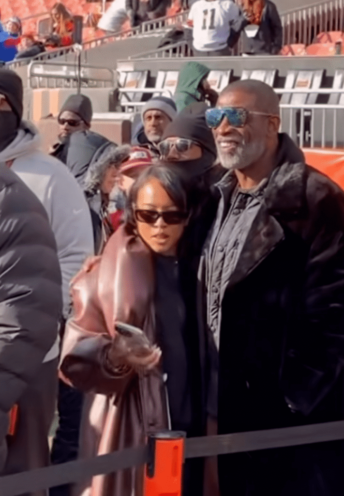karrueche tran and deion sanders support shedeur sanders, with karrueche in a brown puffy leather rowen rose coat