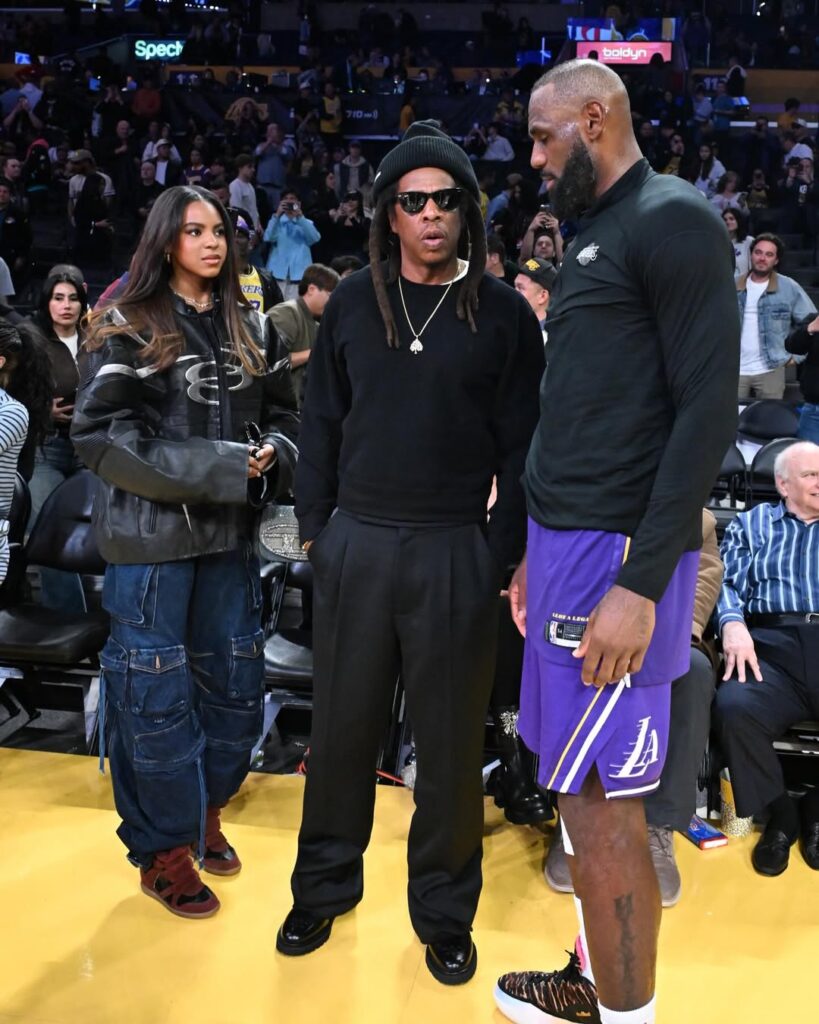 jay z and blue ivy meet lebron james at the lakers game, with blue wearing the same isabel marant sneakers made famous by beyoncé