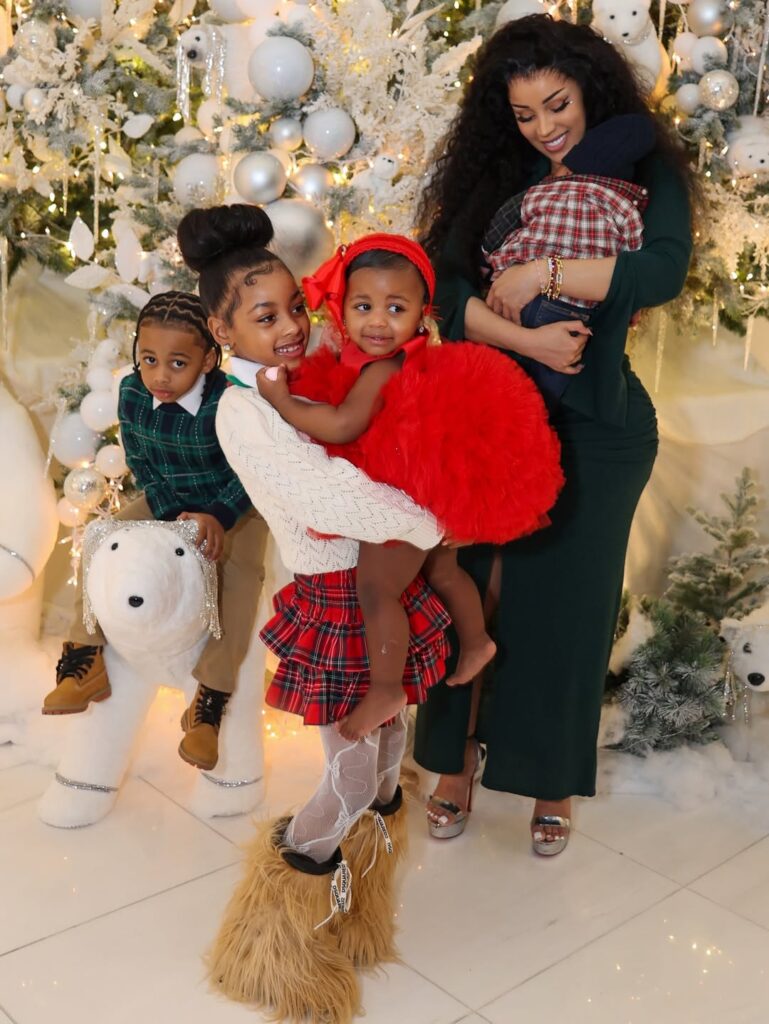 cardi b celebrates christmas with her children in an olive green bodycon dress with silver metallic heels